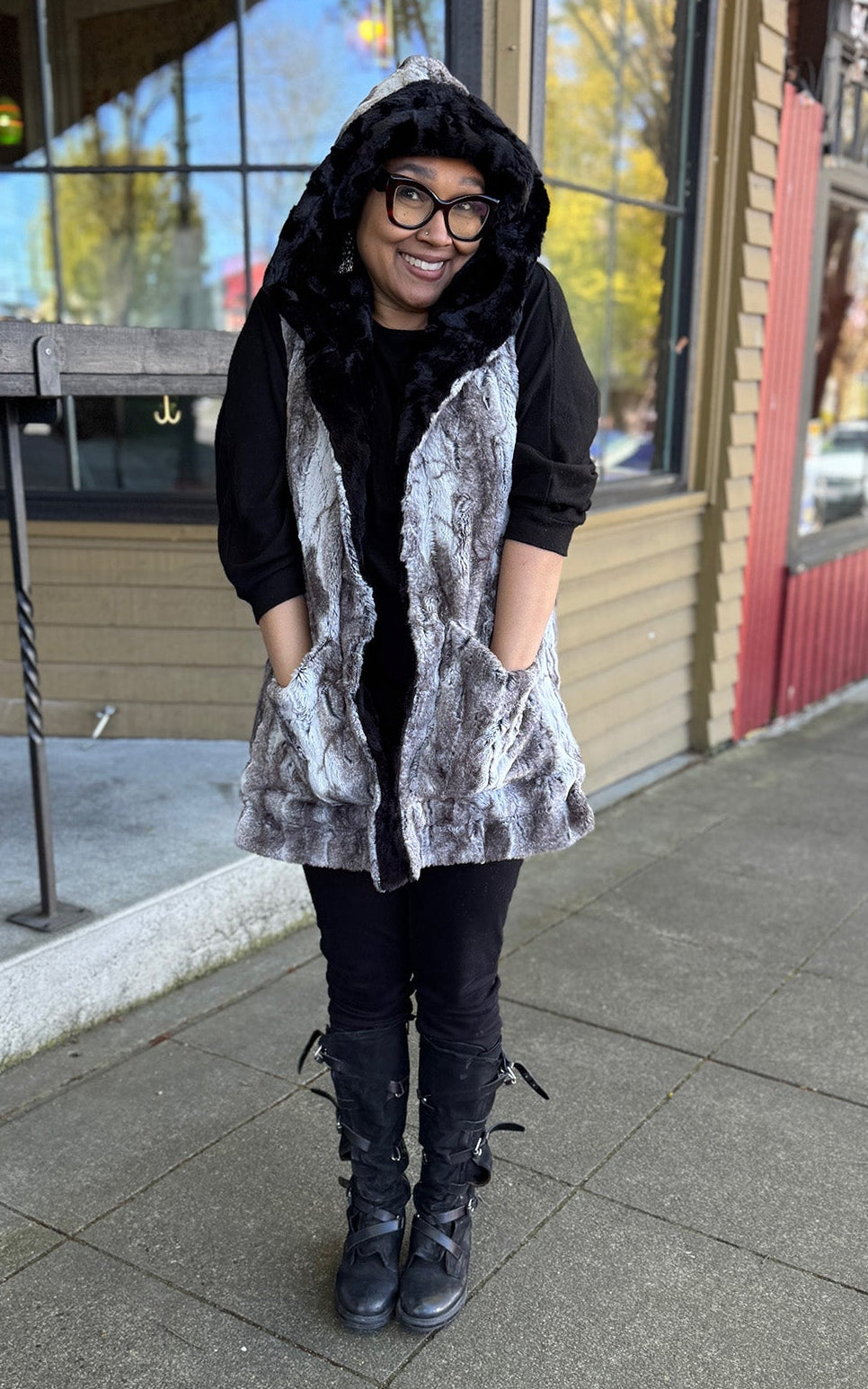 Woman wearing the Oversized Hooded Vest in Rock Steady Faux Fur with hands in pocket and the Hood up.  Handmade in Seattle WA, USA by Pandemonium Millinery