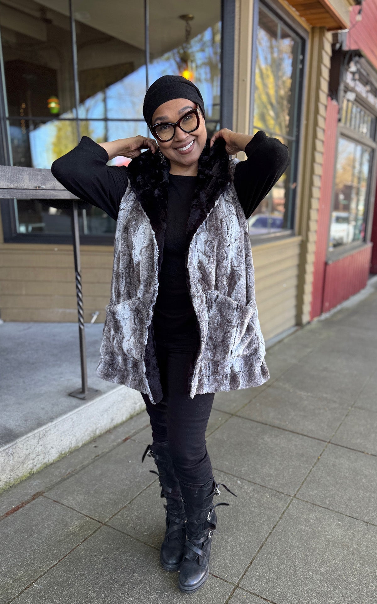 A woman wearing the Oversized Hooded Vest in Rock Steady Faux Fur with hands on down hood.  Handmade in Seattle WA, USA by Pandemonium Millinery