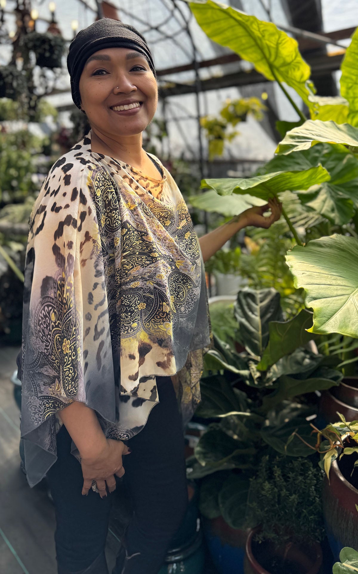 Woman wearing the Lumina Poncho in Party Animal, shown in boat neck styling. Made in Seattle, WA, USA by Pandemonium Seattle.