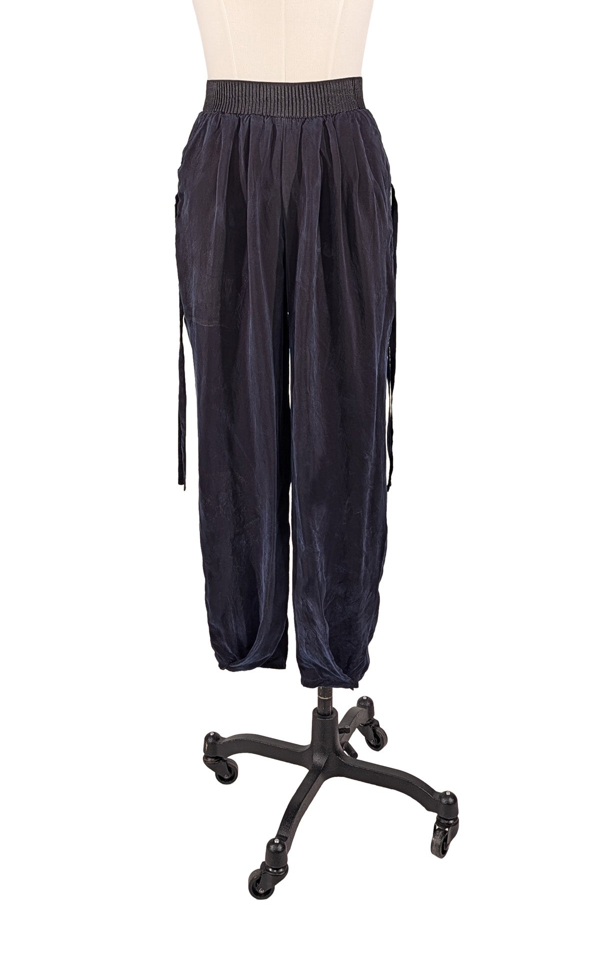 A woman wearing the Pleated Ankle Jogger Pants in Obsidian with the Zipper Top in Egyptian Mirage for a fun match up. Made in Seattle, WA, USA by Pandemonium Seattle.