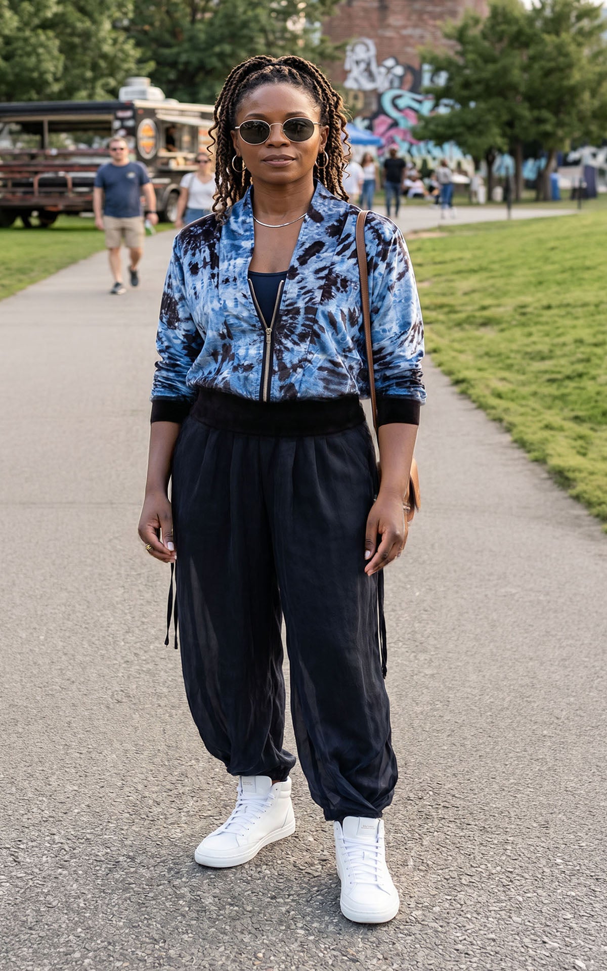 A woman wearing the Pleated Ankle Jogger Pants in Obsidian with the Zipper Top in Egyptian Mirage for a fun match up. Made in Seattle, WA, USA by Pandemonium Seattle.