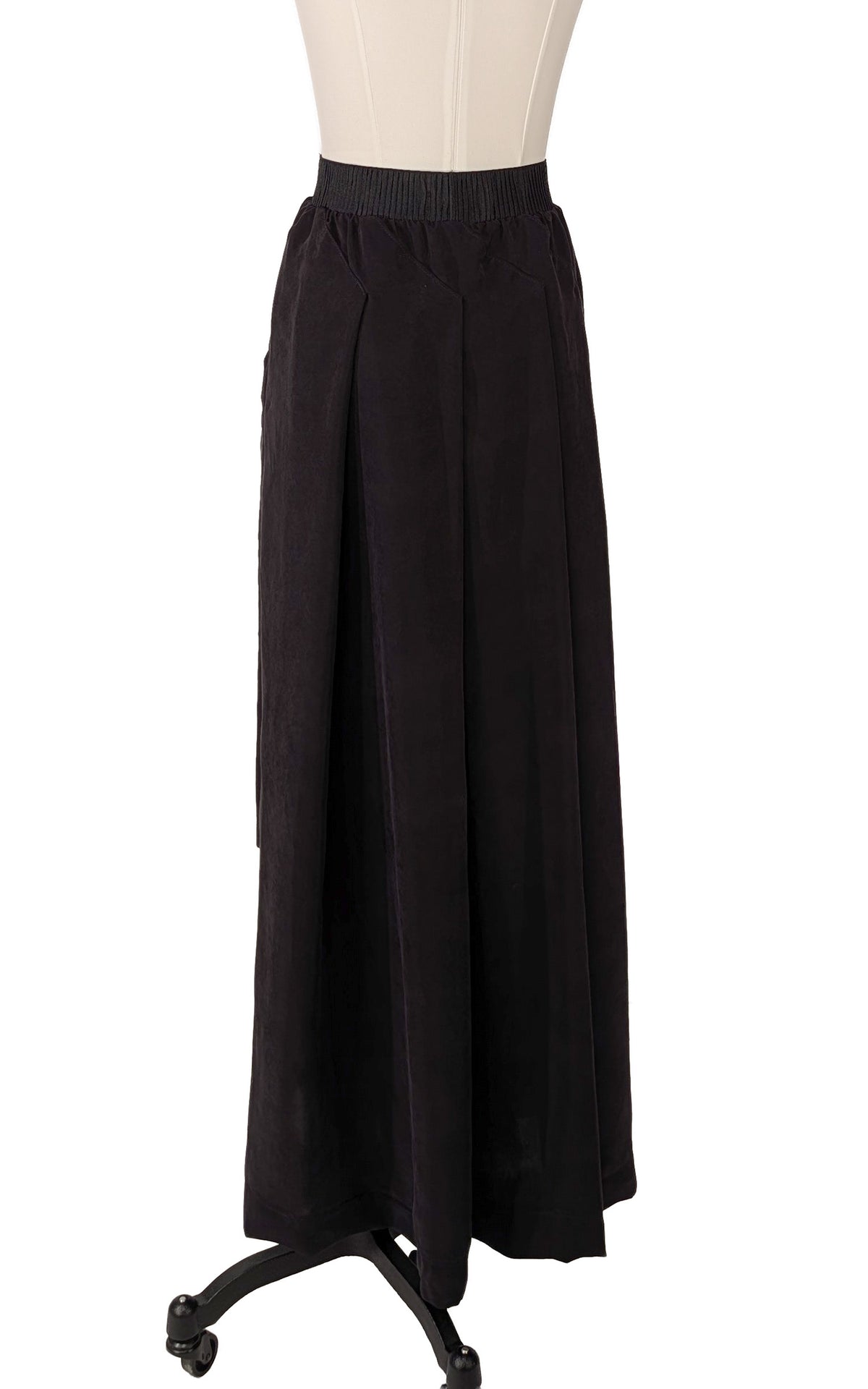 Pleated Maxi Skirt in Cupro Obsidian Black. Shown on a dress form. Made in Seattle, WA, USA by Pandemonium Seattle.