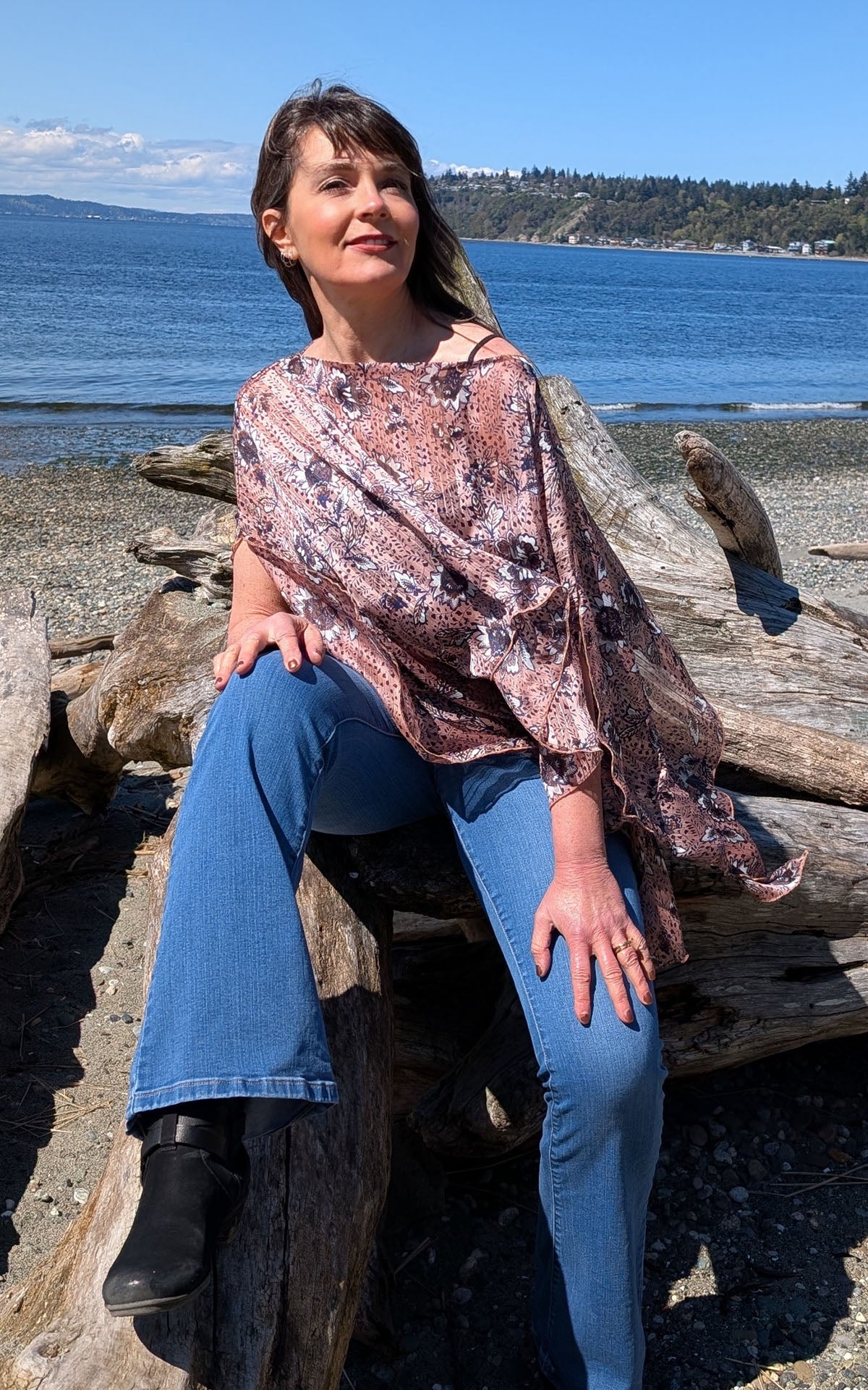 Woman at the beach wearing the Lumina Poncho in Hippy Chick. Made in Seattle, WA, USA by Pandemonium Seattle.