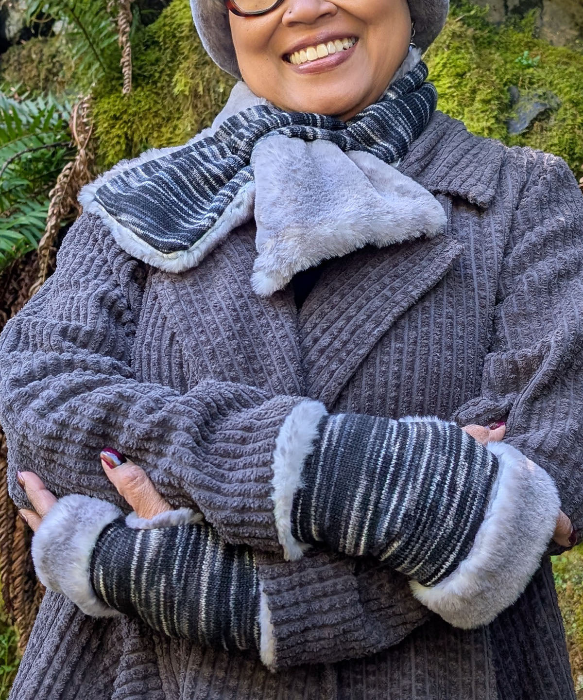 Woman wearing Sweet Stripes Fingerless Gloves in Blackberry Cobbler and Olympic Fog Faux Fur. Made in Seattle, WA, USA by Pandemonium Seattle.