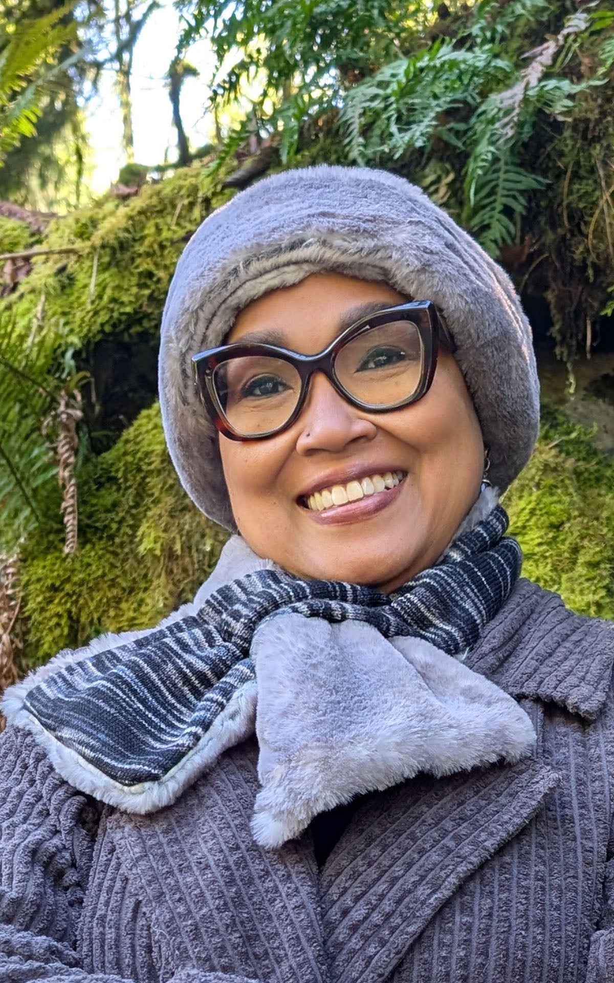 Woman wearing the Pull-Thru Scarf in Sweet Stripes Blackberry Cobbler and Olympic Fog with the matching Beanie, shown close up. Made in Seattle, WA, USA by Pandemonium Seattle.