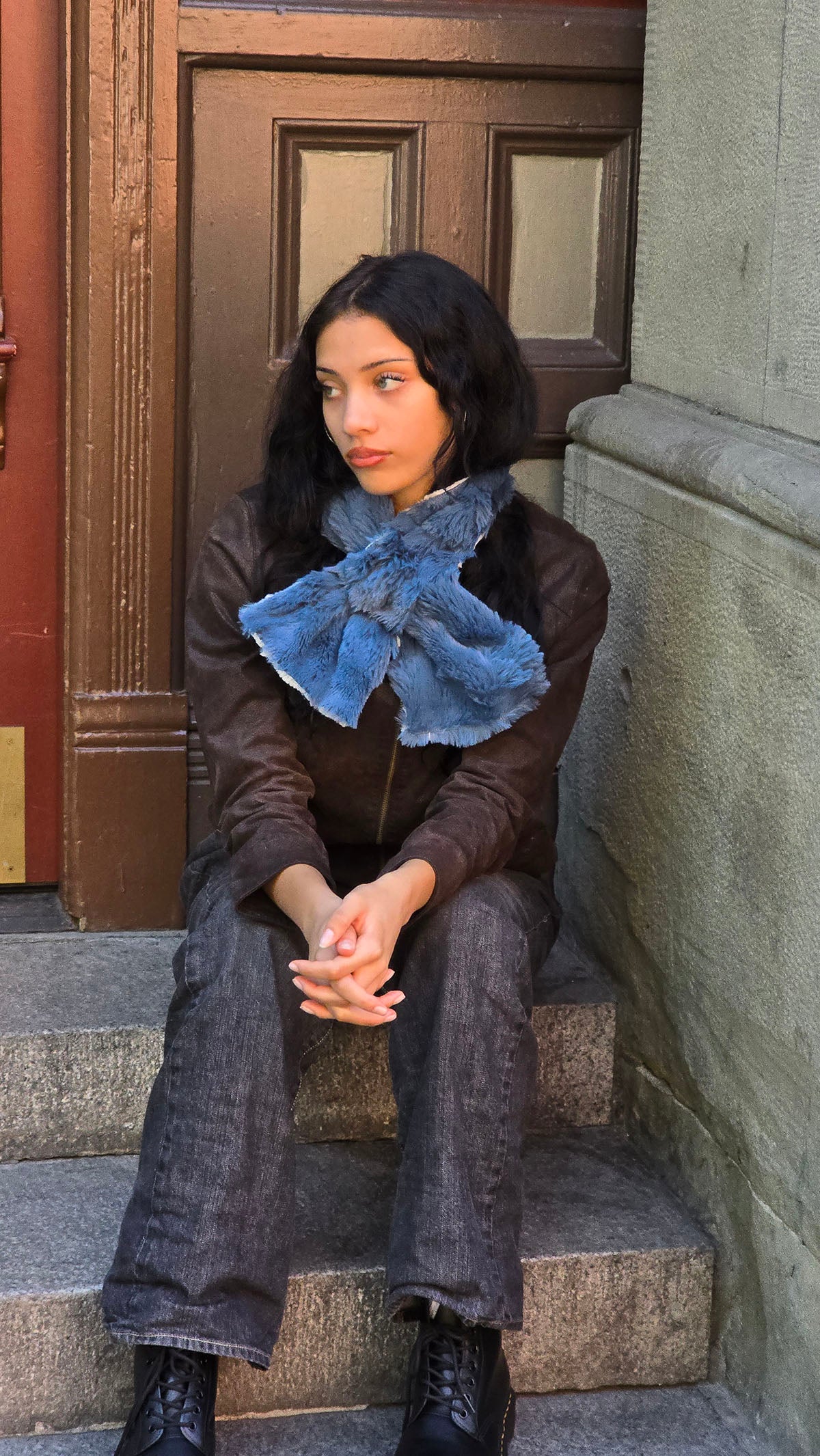 A woman wearing the reversible Pull-Thru Scarf in Bluebell and Winters Frost faux furs, with the Bluebell side out. Made in Seattle, WA, USA by Pandemonium Seattle.