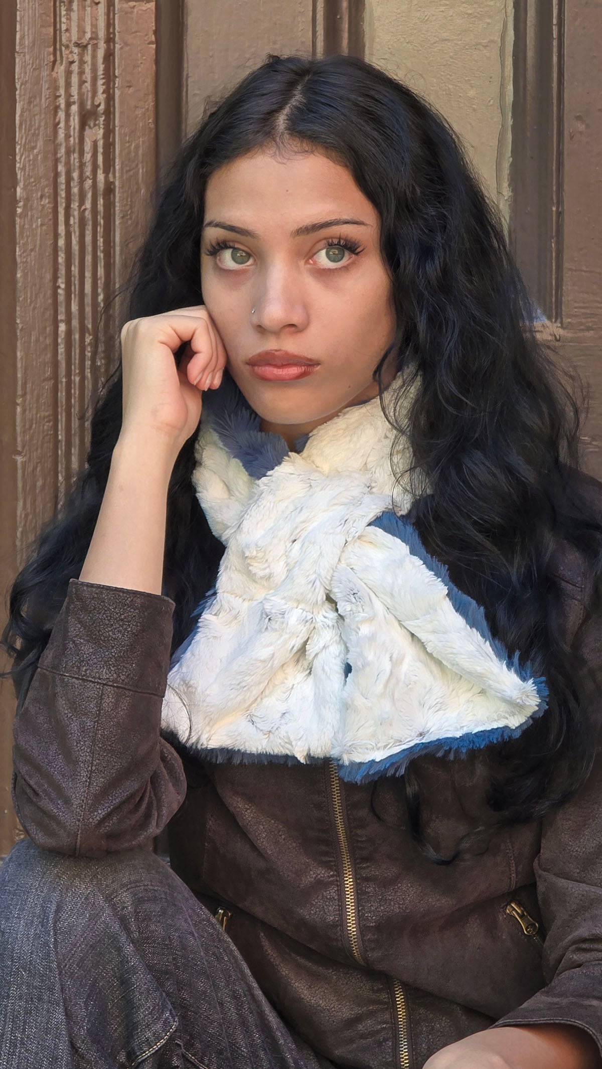A woman wearing the reversible Pull-Thru Scarf in Bluebell and Winters Frost faux furs. Made in Seattle, WA, USA by Pandemonium Seattle.
