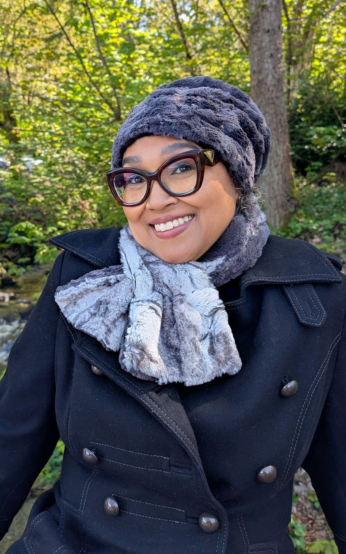Woman in the forest is wearing a Pull thru Scarf in Smoke Show Faux Fur. Handmade in Seattle, WA, USA. By Pandemonium Seattle                 