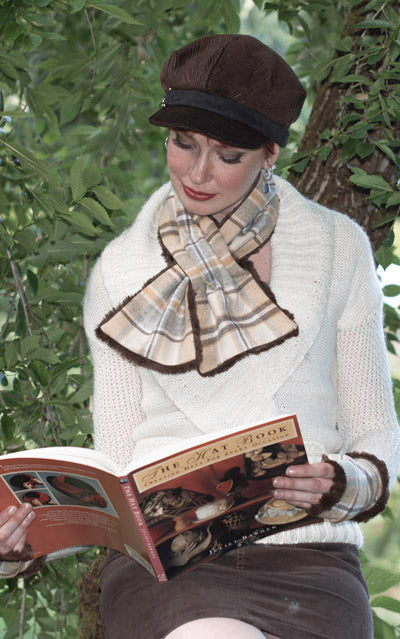 Women sitting in tree reading a book wearing a Valerie cap style hat and a  reversible Pull Through Scarf | Wool Plaid in Day Break, yellow cream brown, and blue  with Cuddly Faux Fur in chocolate | Handmade in Seattle WA | Pandemonium Millinery