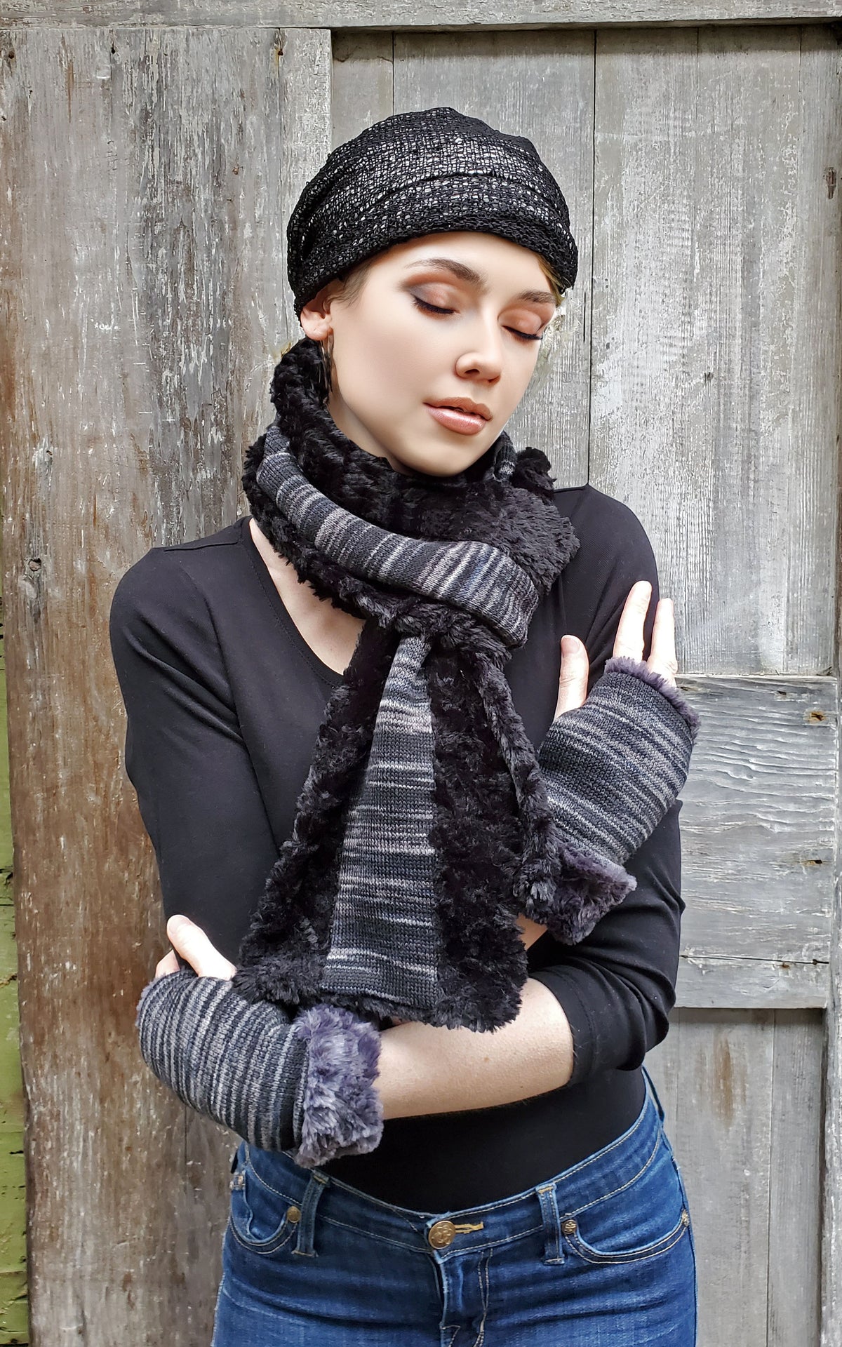 Model against barn door  wearing Classic Scarf, fingerless gloves and rowdy hat   | Sweet Stripes in Blackberry cobbler, blues and grays with  Cuddly Faux Fur in Black | Handmade in Seattle WA Pandemonium Millinery
