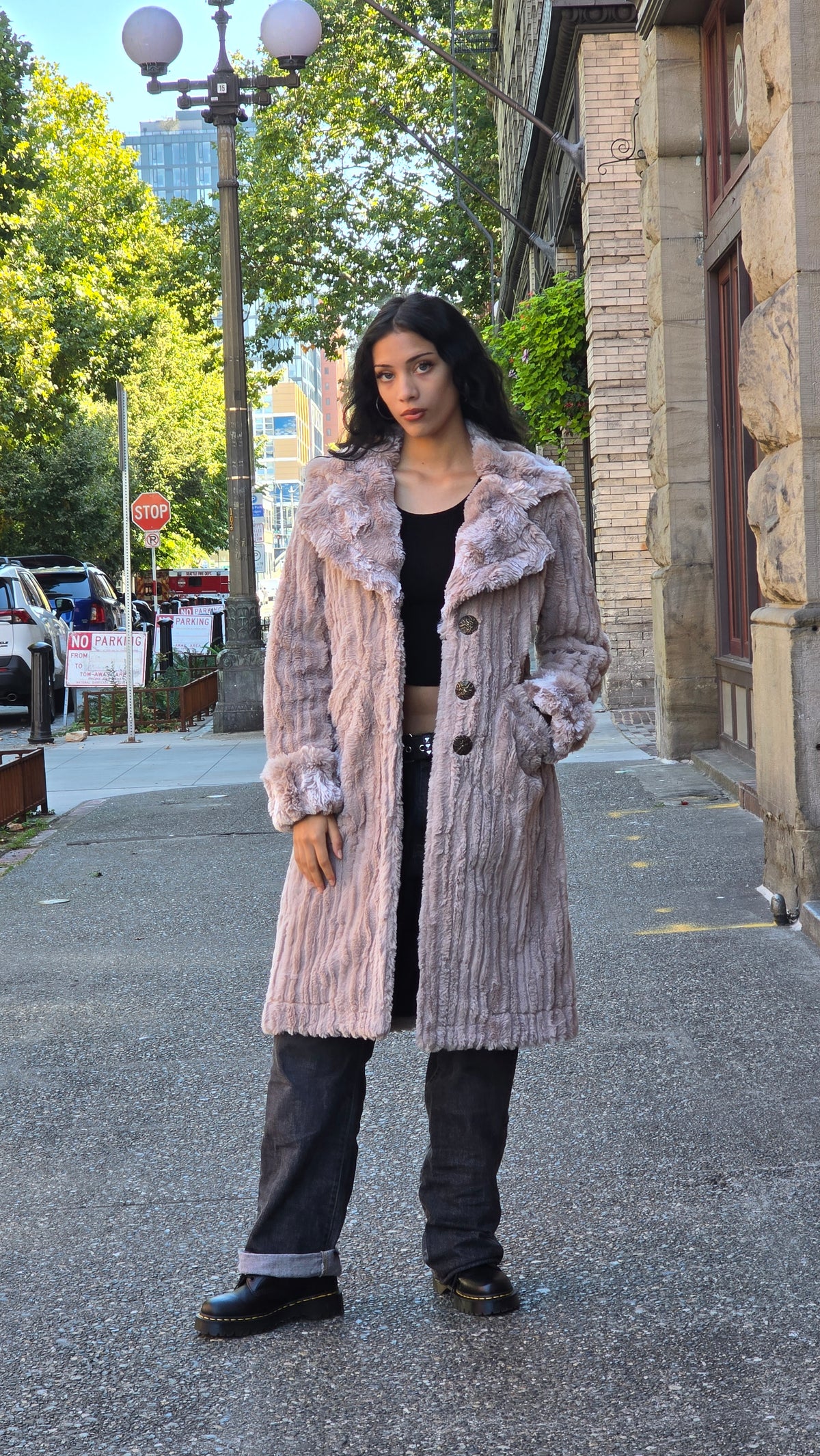 Woman wearing the Roxy Coat in Cirrus in Honey and Cloudwalk Honey Cuffs and Collar. Made in Seattle, WA, USA by Pandemonium Seattle.