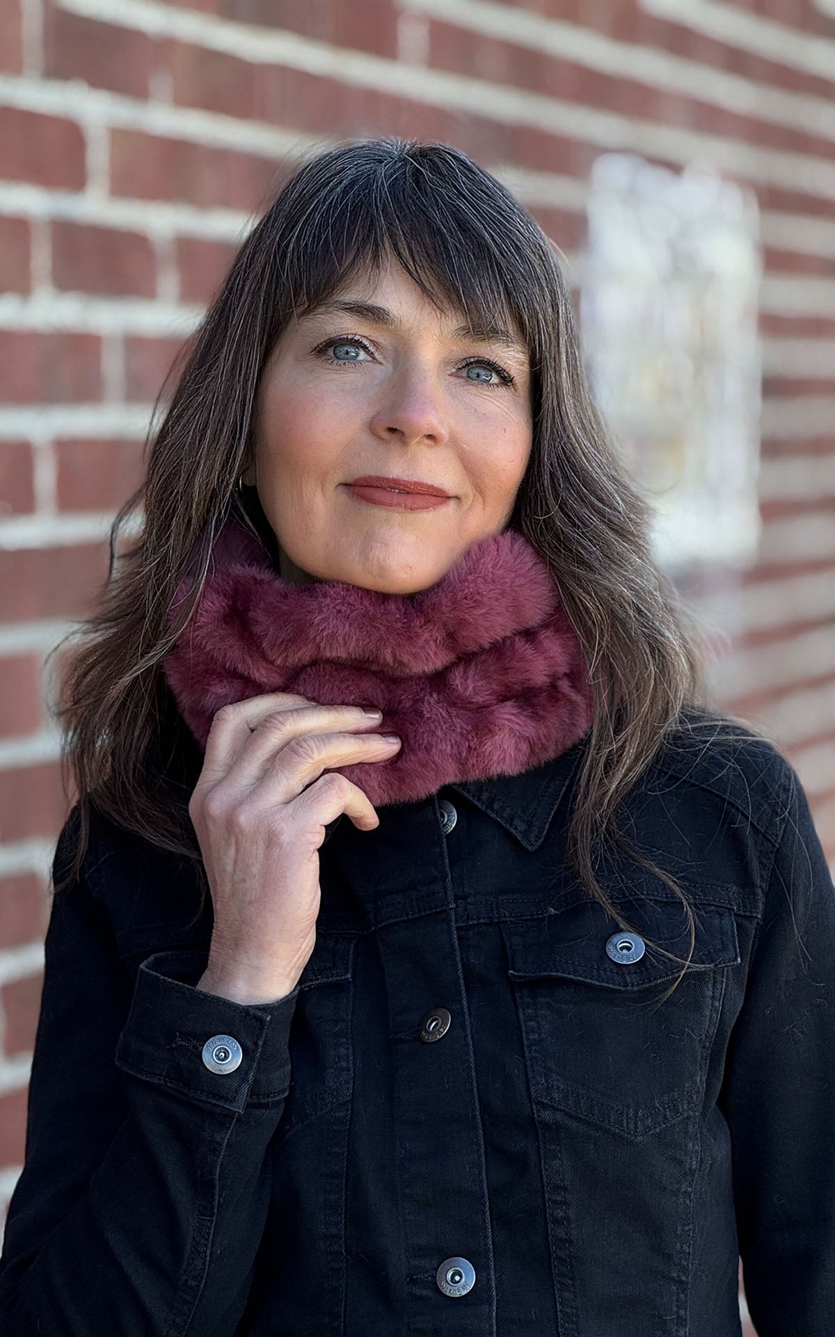 Woman wearing the Royal Opulence Ear Neck Cozy Wide  in Maple Glow as a neck warmer. Made in Seattle, WA, USA by Pandemonium Seattle.