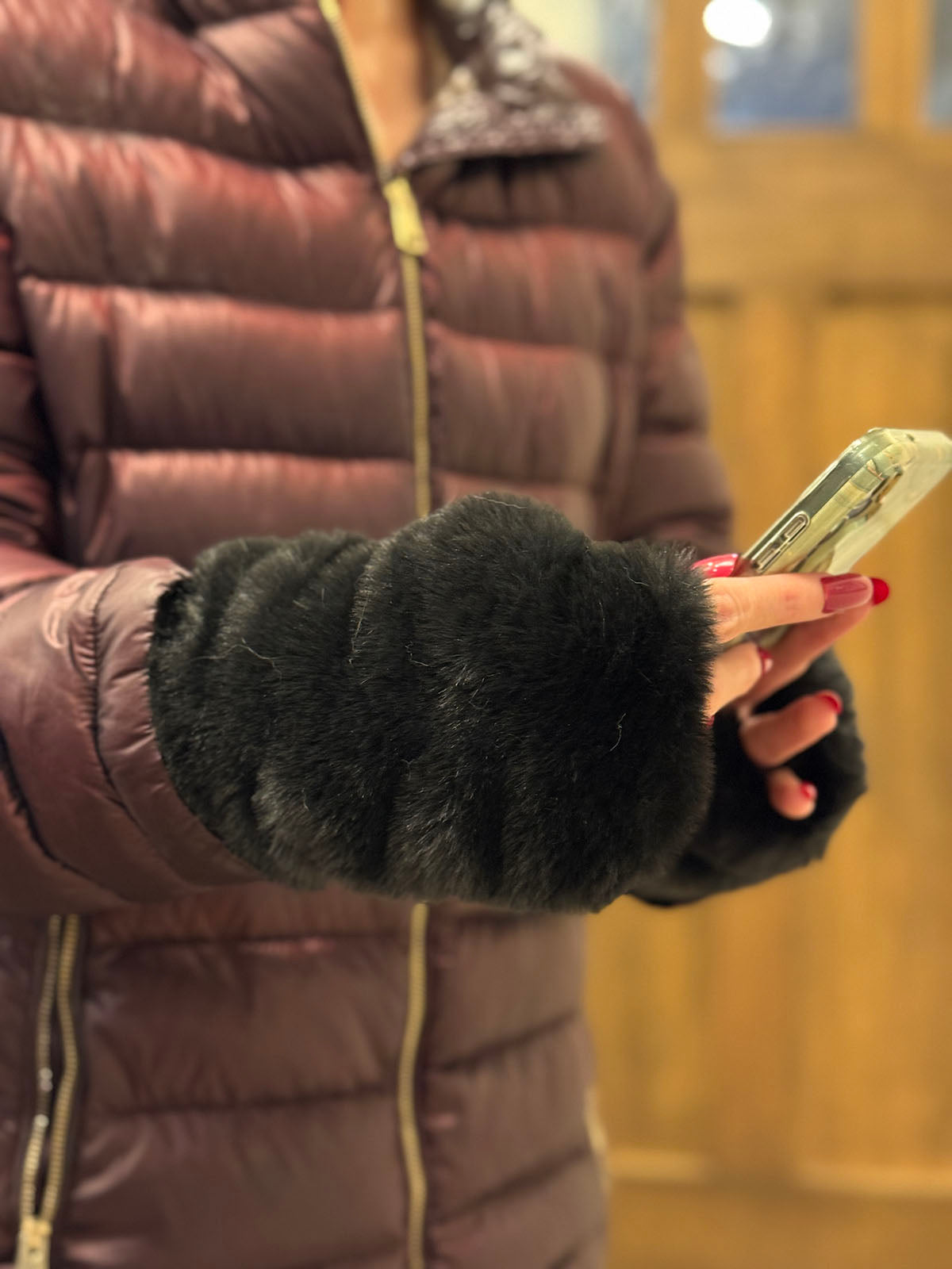 Woman wearing Royal Opulence Fingerless Gloves Short in Onyx, while holding a cell phone. Made in Seattle, WA, USA by Pandemonium Seattle.