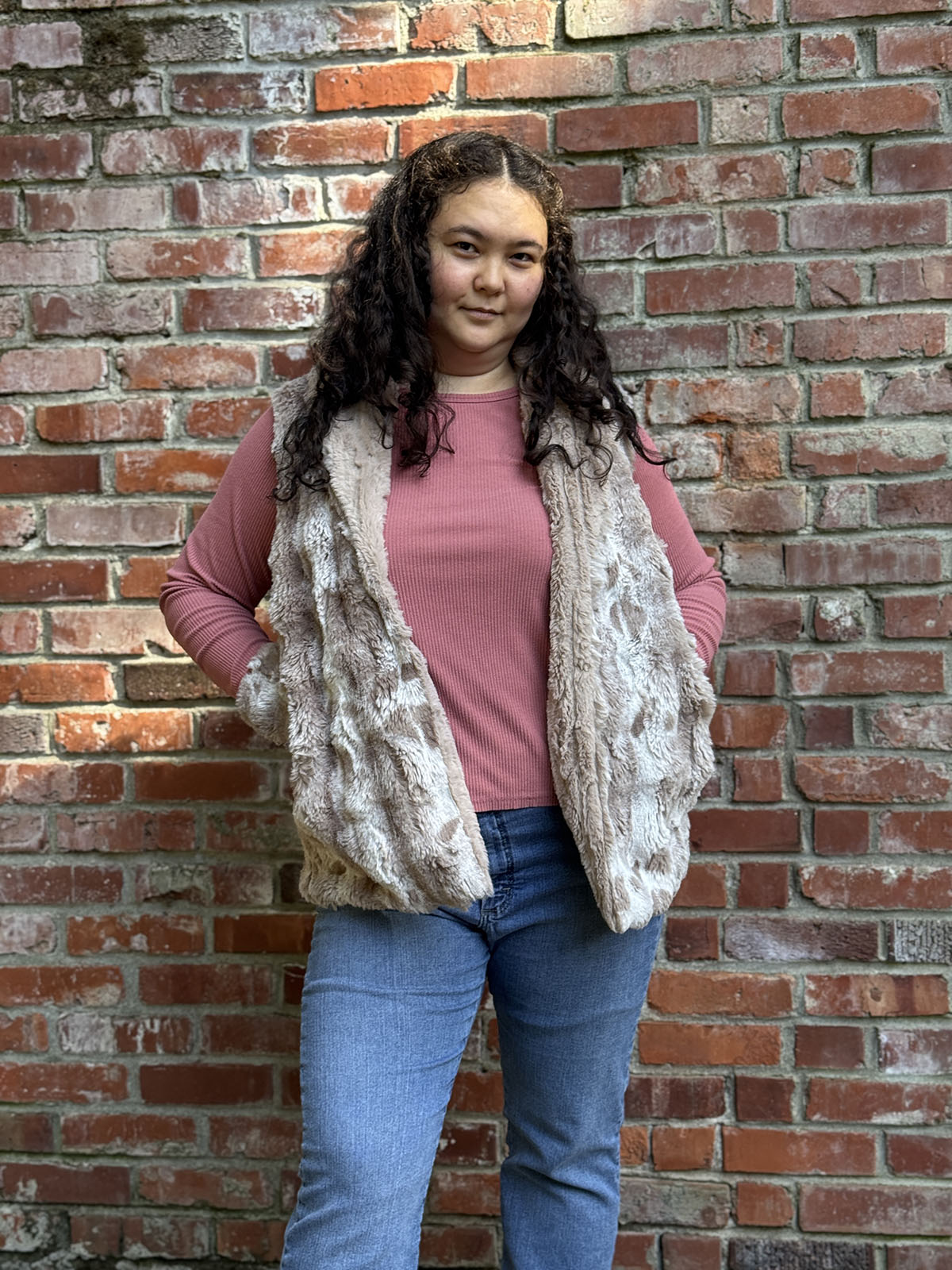 Woman wearing the Shawl Collar Vest in Cloudwalk Honey with reversible Cirrus Honey faux furs. Hand sewn in Seattle, Washington by Pandemonium Seattle.