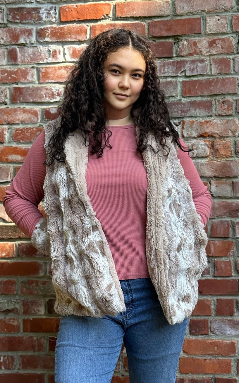 Woman wearing the Shawl Collar Vest in Cloudwalk Honey with reversible Cirrus Honey faux furs.  Hand sewn in Seattle, Washington by Pandemonium Seattle.