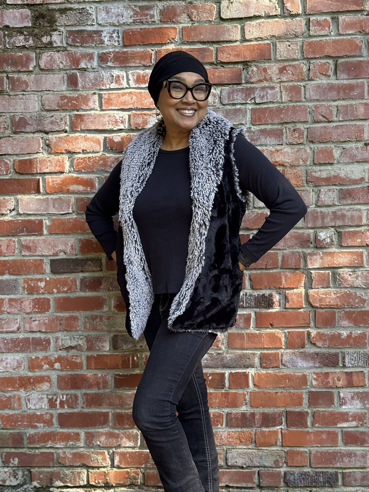 Woman wearing the Shawl Collar Vest in Cuddly Black and Silver Tipped Fox in Black. Handmade in Seattle, WA, USA by Pandemonium Millinery.