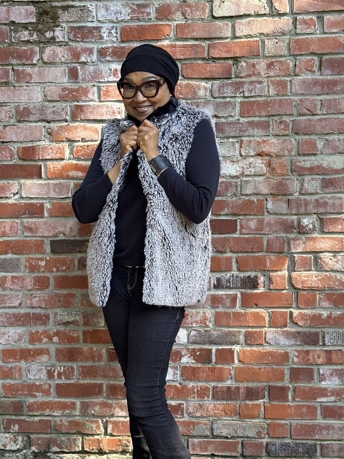 Woman wearing the Shawl Collar Vest in Cuddly Black and Silver Tipped Fox in Black. Shown reversed. Handmade in Seattle, WA, USA by Pandemonium Millinery.