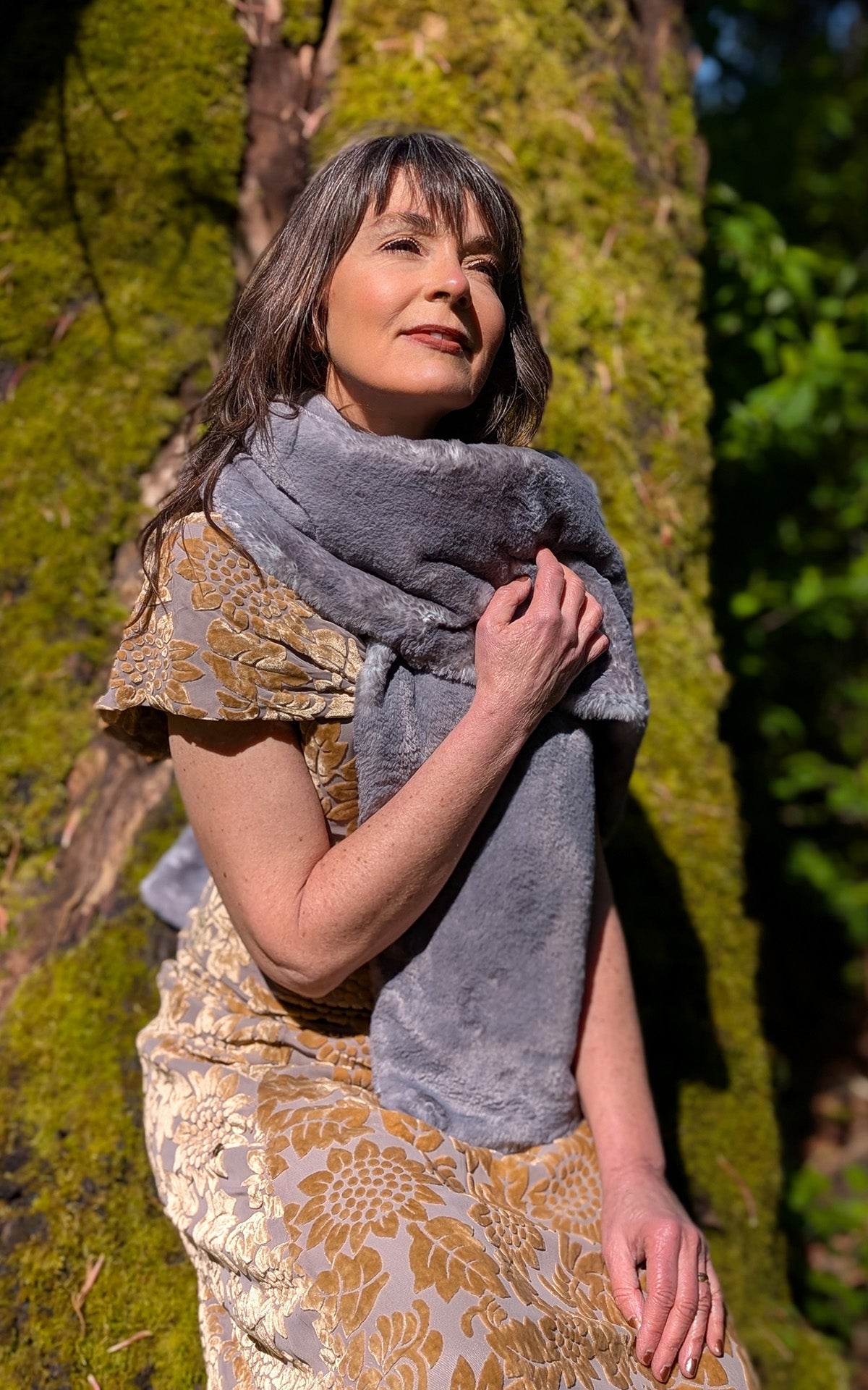 Woman posing with hand over heart is wearing a Stole in Olympic Fog Faux Fur. Handmade in Seattle, WA, USA.  By Pandemonium Seattle