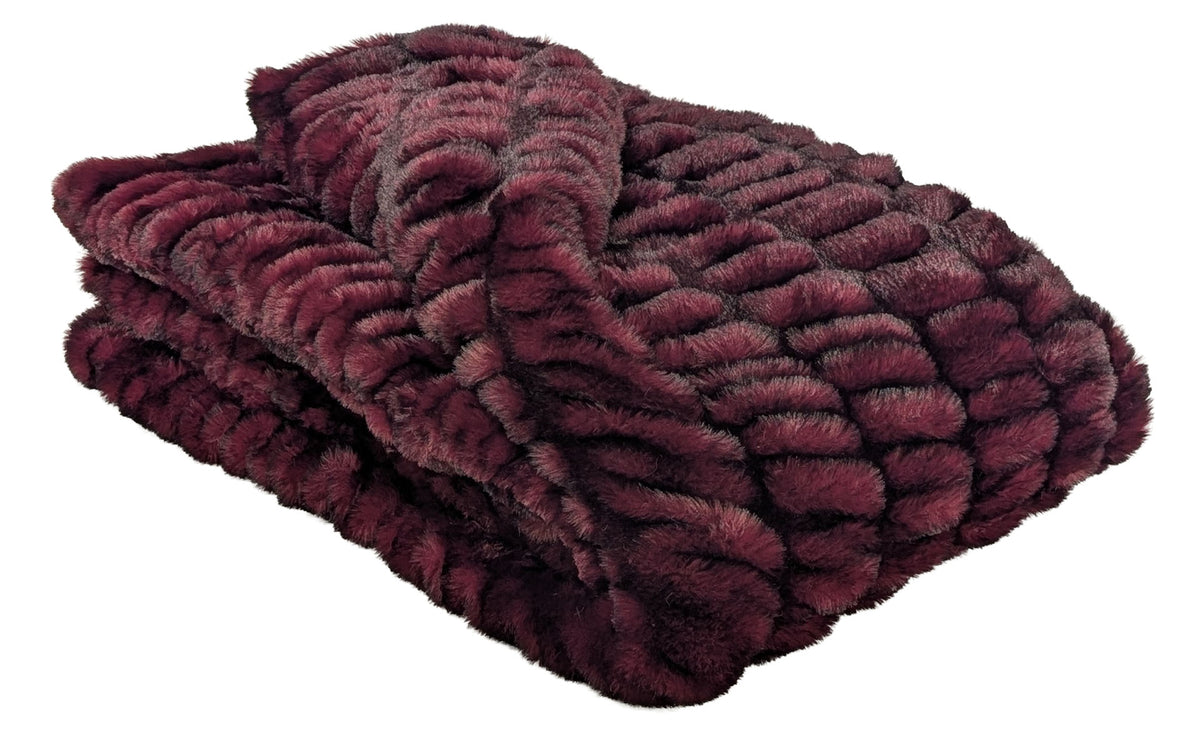 Royal Opulence Cherry Bomb Faux Fur Throw Blanket, shown folded and displayed against a white background. Made in Seattle, WA, USA by Pandemonium Seattle.
