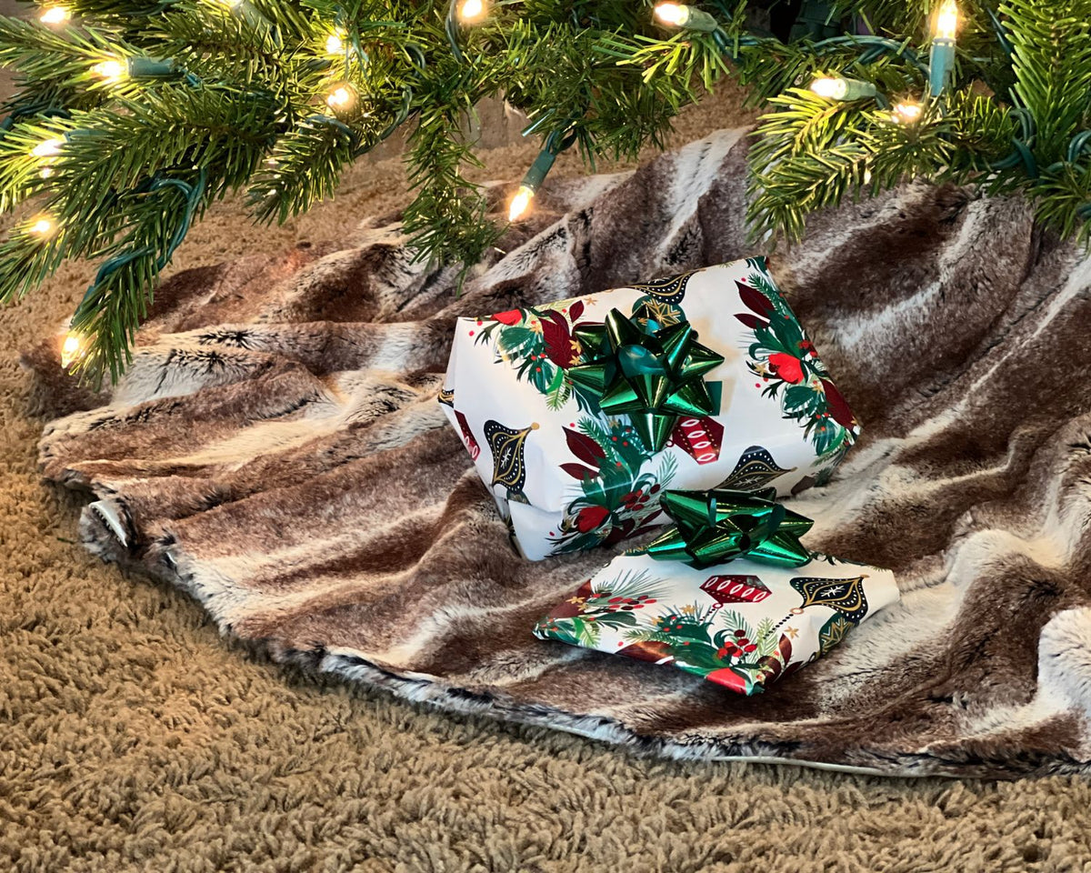 Close up of the Birch Faux Fur Tree Skirt under a lit Christmas Tree. Made in Seattle, WA, USA. Pandemonium Seattle.