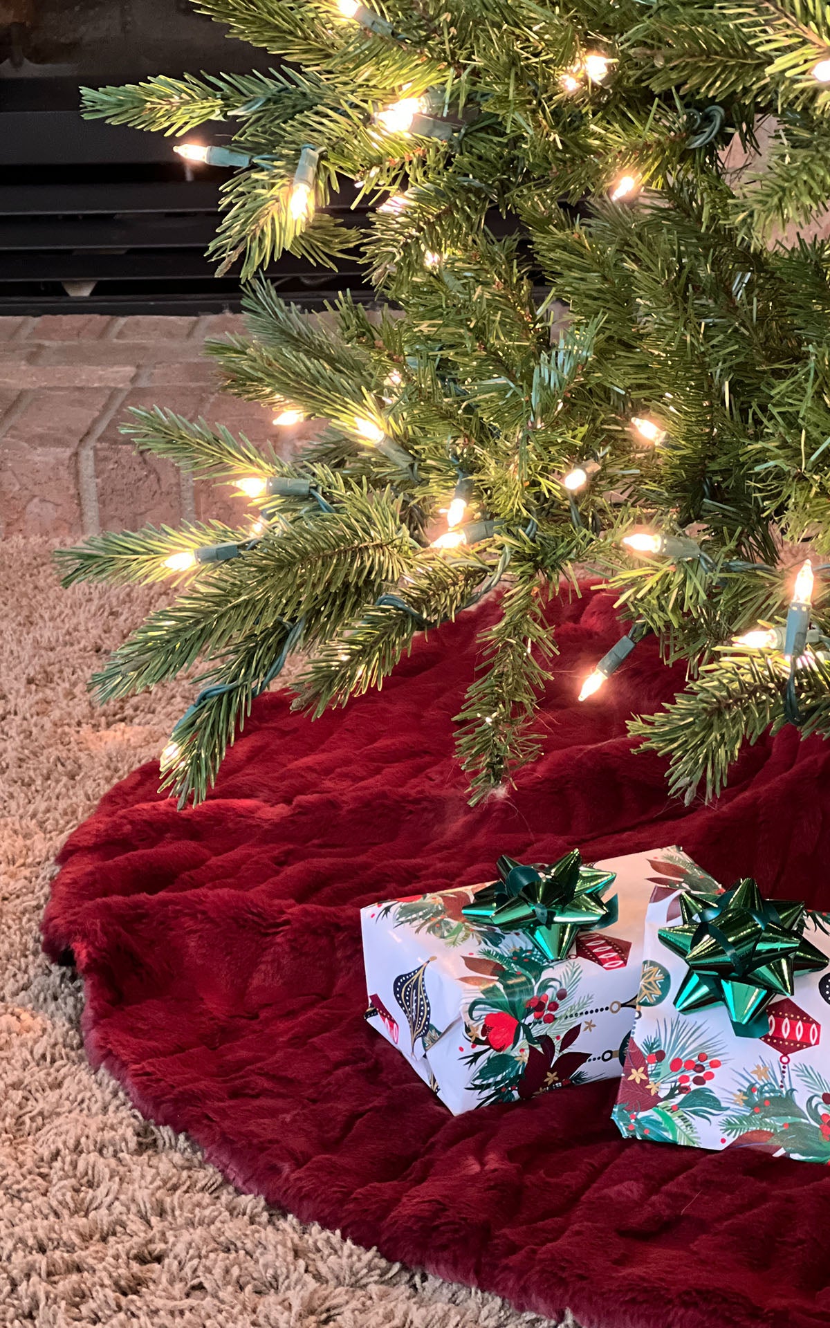 Cranberry Creek Faux Fur Tree Skirt under a lit Christmas Tree with gifts. Made in Seattle, WA, USA. Pandemonium Seattle.