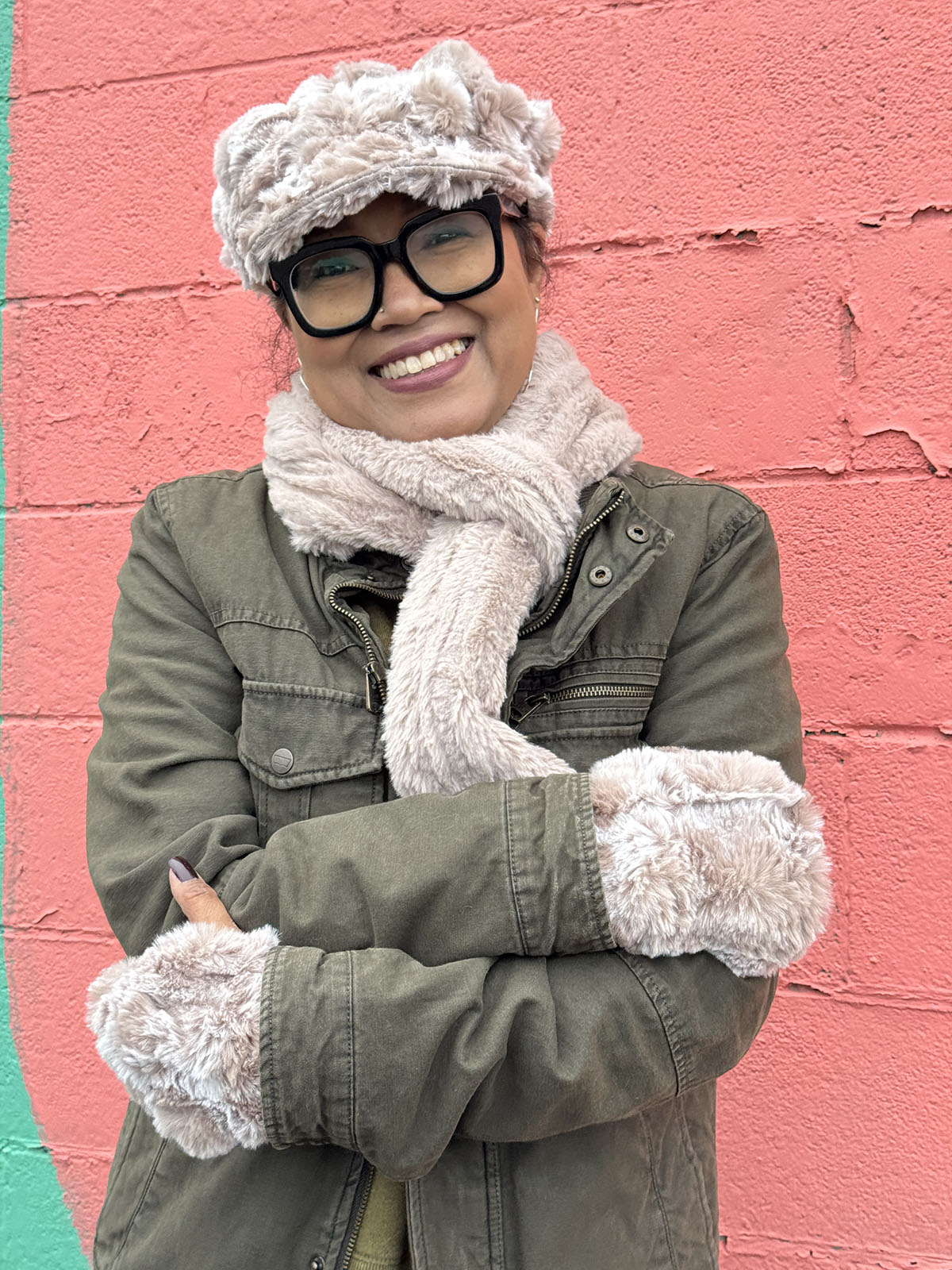 Woman wearing the Classic Scarf in Cirrus Honey, shown wrapped close to her neck for warmth. Hand sewn in Seattle, Washington by Pandemonium Seattle.