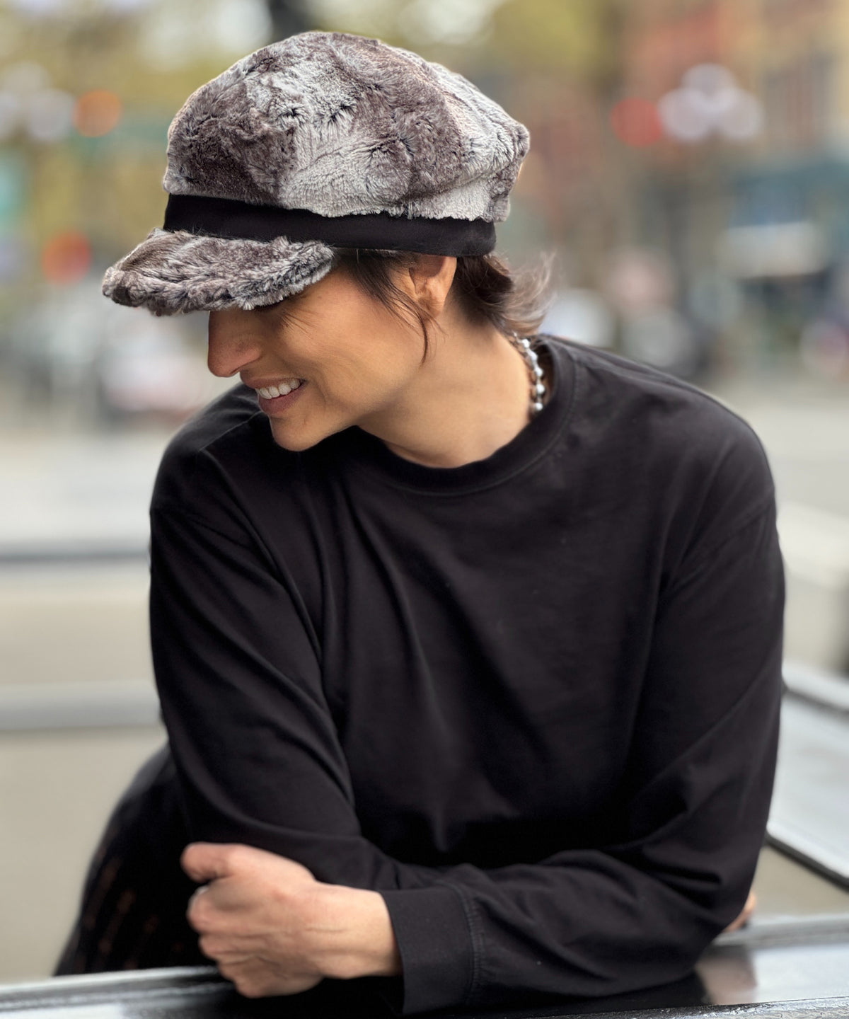 Alternate view of woman wearing the Valerie Cap in Rock Steady Faux Fur with a black band and buckle. Made in Seattle, WA, USA by Pandemonium Seattle.