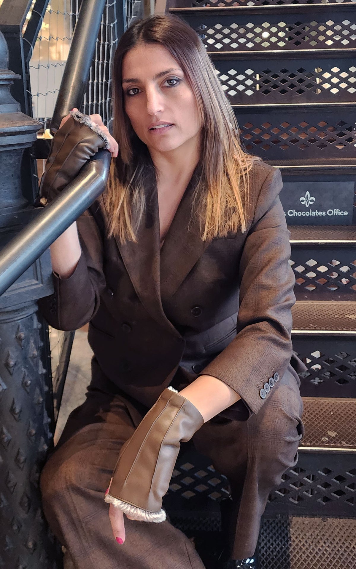 Model on stairs wearing Fingerless Gloves | Vegan Leather in Chocolate with Assorted Faux Fur | Pandemonium Millinery