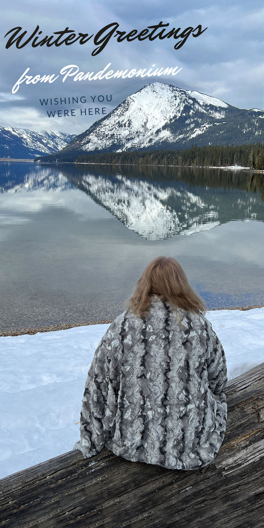 Woman with Faux Fur Blanket wrapped around her while looking at the mountains mobile banner