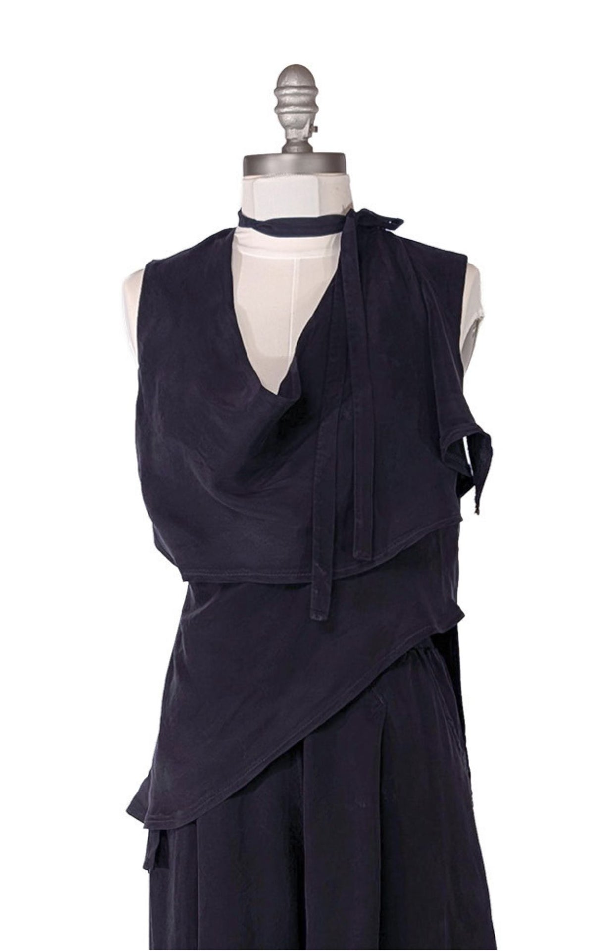 The sleeveless Wrap Top in Inkwell navy Cupro fabric, shown wrapped and tied at both the waist and additionally as a neck choker. Shown with matching Wide Leg Pleated Pants. Made in Seattle, WA, USA by Pandemonium Seattle.