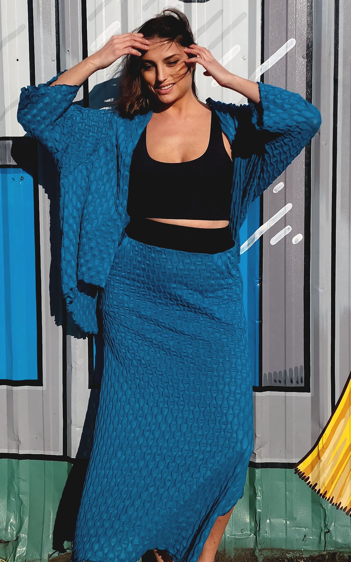 Model in A-Line Skirt and Cardigan in Cerulean Blue, from the LYC/Pandemonium Seattle Fractal Collection. Handmade in Seattle, WA, USA.