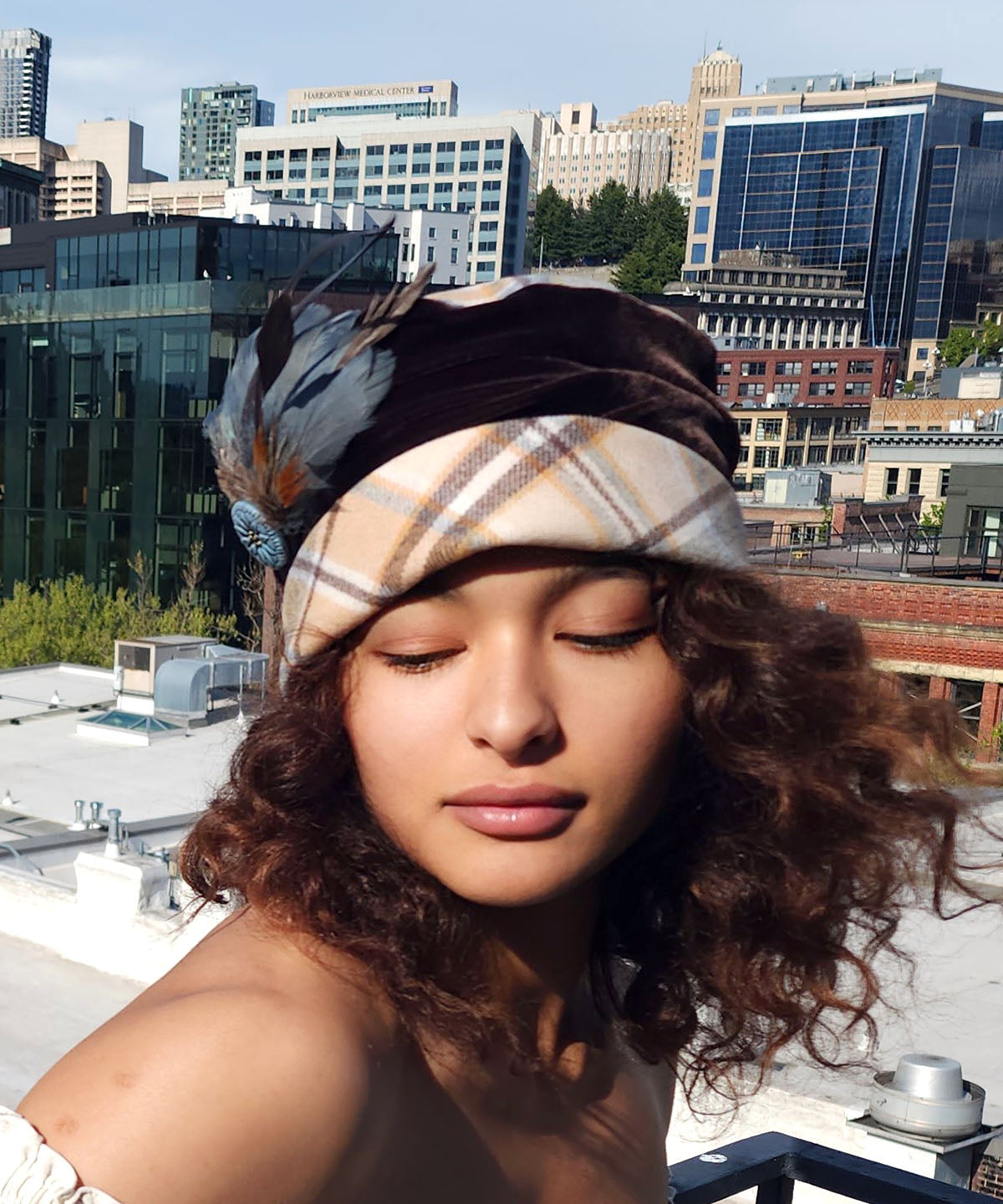 Woman wearing Ana Cloche  Style hat in Daybreak Plaid with Feather and Button Trim | Handmade By Pandemonium Millinery | Seattle WA USA