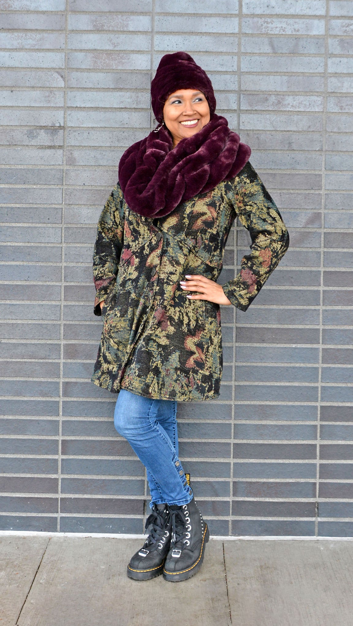 Model wearing Royal Opulence Burgundy Faux Fur Shoulder Wrap as a coat collar by Pandemonium Seattle.