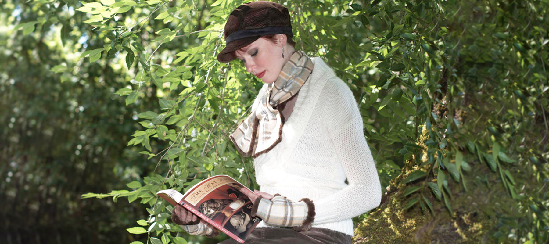 Woman Reading Book wearing Brown Cap and Wool Plaid Scarf and Gloves