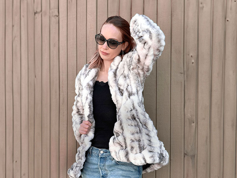 woman wearing a plush white and gray coat in aspen faux fur handmade in the usa by pandemonium seattle