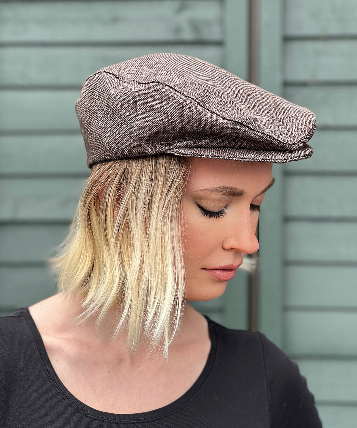 Woman wearing Pandemonium Millinery Charlie Driving Cap | Origin Upholstery Fabric in Java Brown | Handmade in Seattle WA