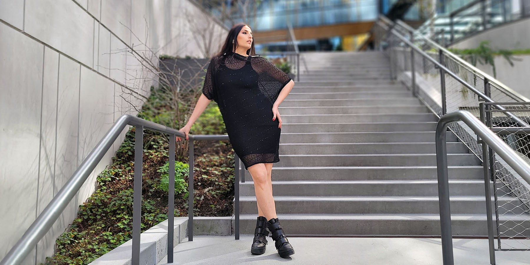 woman standing on stairs wearing a black sequin dress handmade in America by Leigh Young Collection