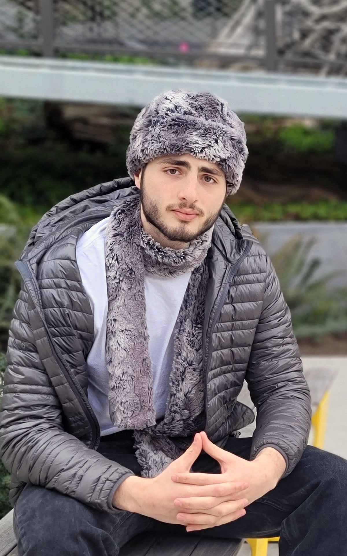 Man sitting outside wearing a  Beanie and matching Classic Skinny Skinny Scarf | Seattle sky, gray faux fur | Handmade by Pandemonium Millinery Seattle, WA USA