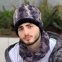 man wearing faux fur pillbox with matching neck warmer handmade by Pandemonium Millinery in the USA
