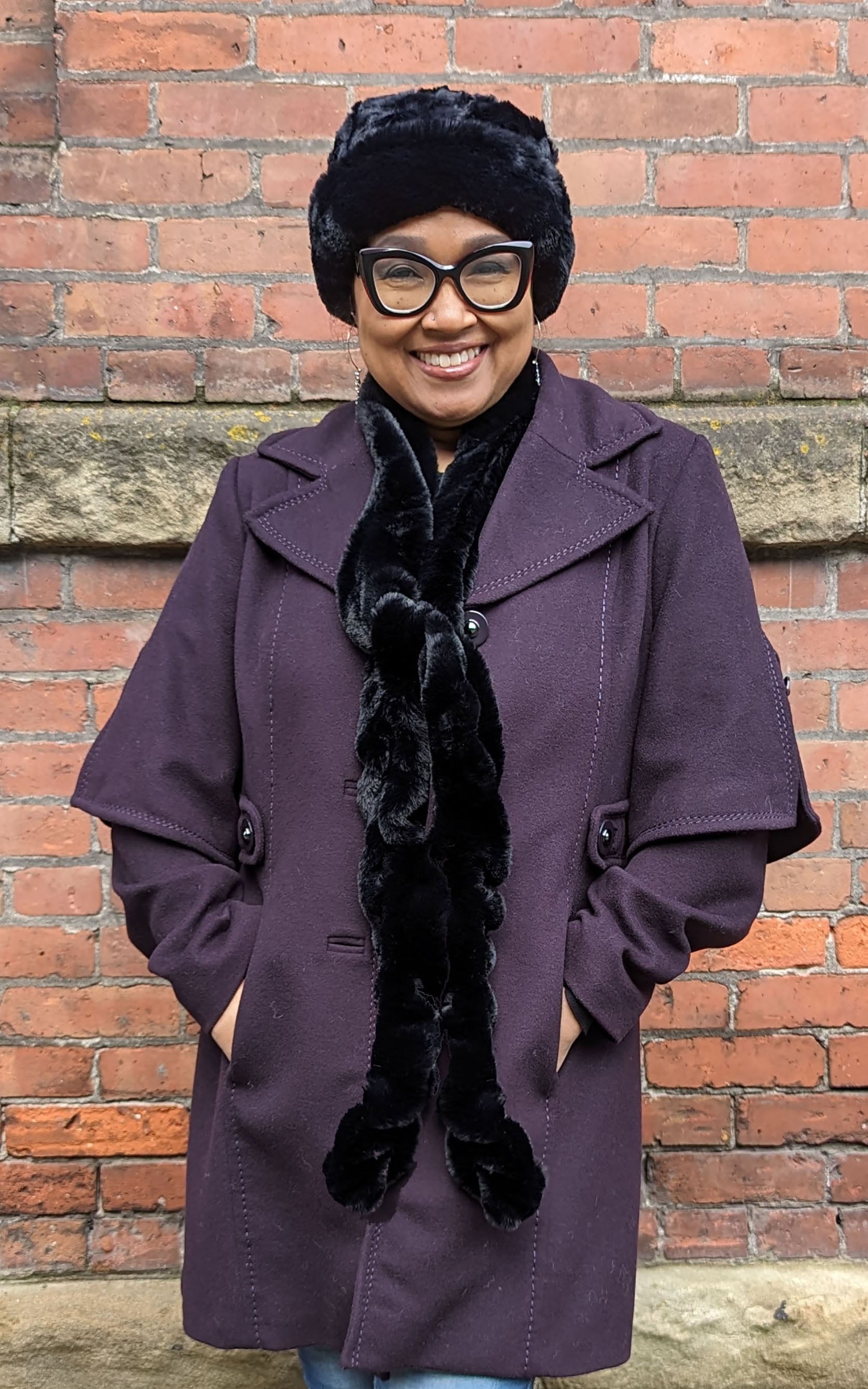 Woman wearing the Royal Opulence Skinny Scarf in Maple Glow Handmade by Pandemonium Seattle.