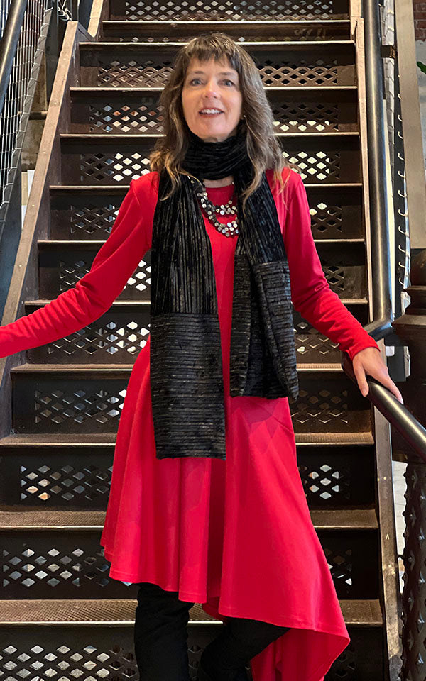 Woman wearing red dress paired with an Evening Wrap in Night Owl Pleated Velvet handmade in USA by Pandemonium Seattle