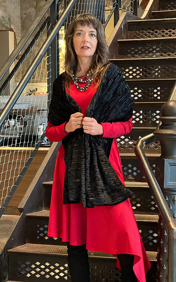 Woman wearing red dress paired with an Evening Wrap in Night Owl Pleated Velvet handmade in USA by Pandemonium Seattle