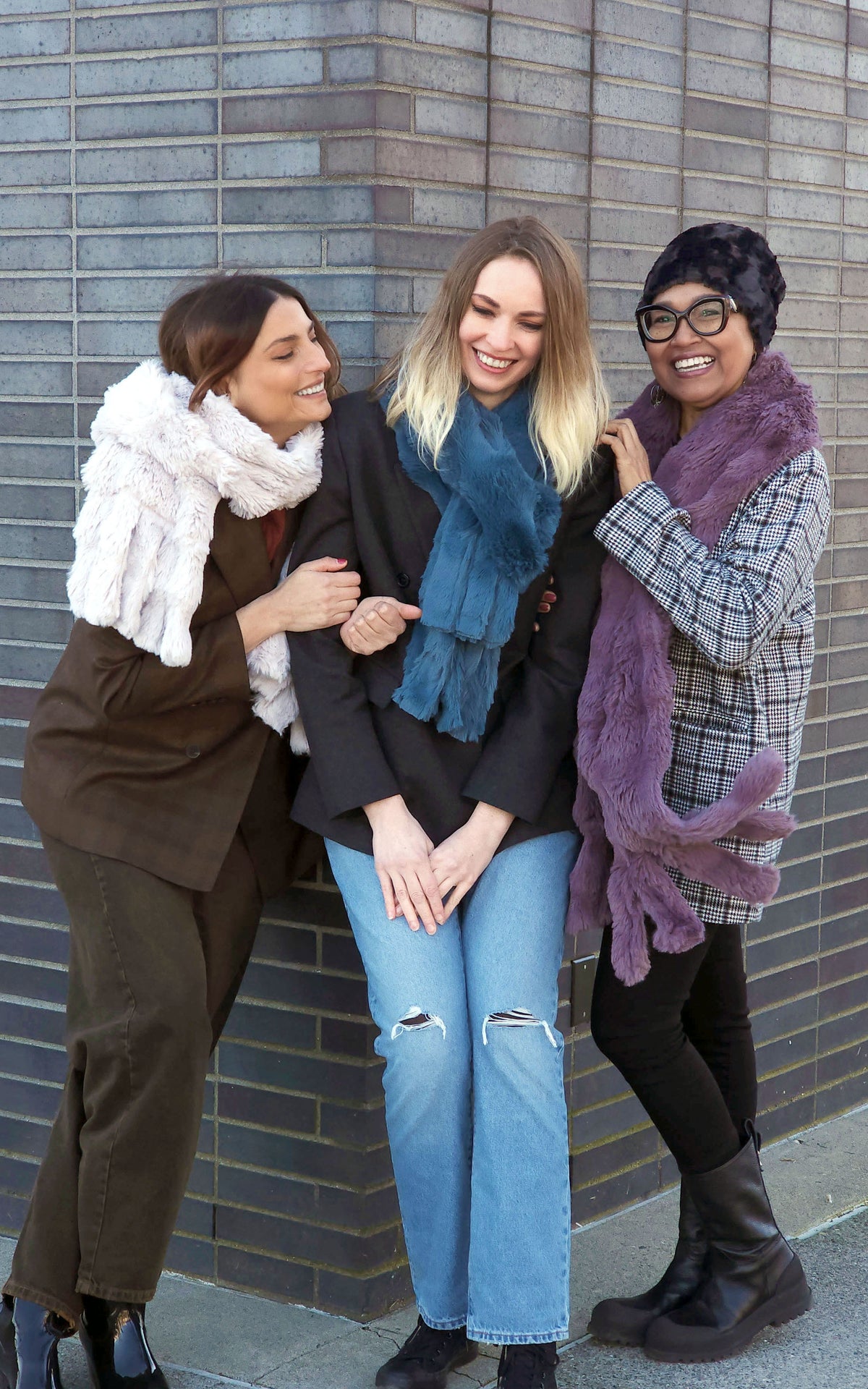 3 women grouped together wearing three colors of the  Fringe Faux Fur Fringe Scarf by Pandemonium