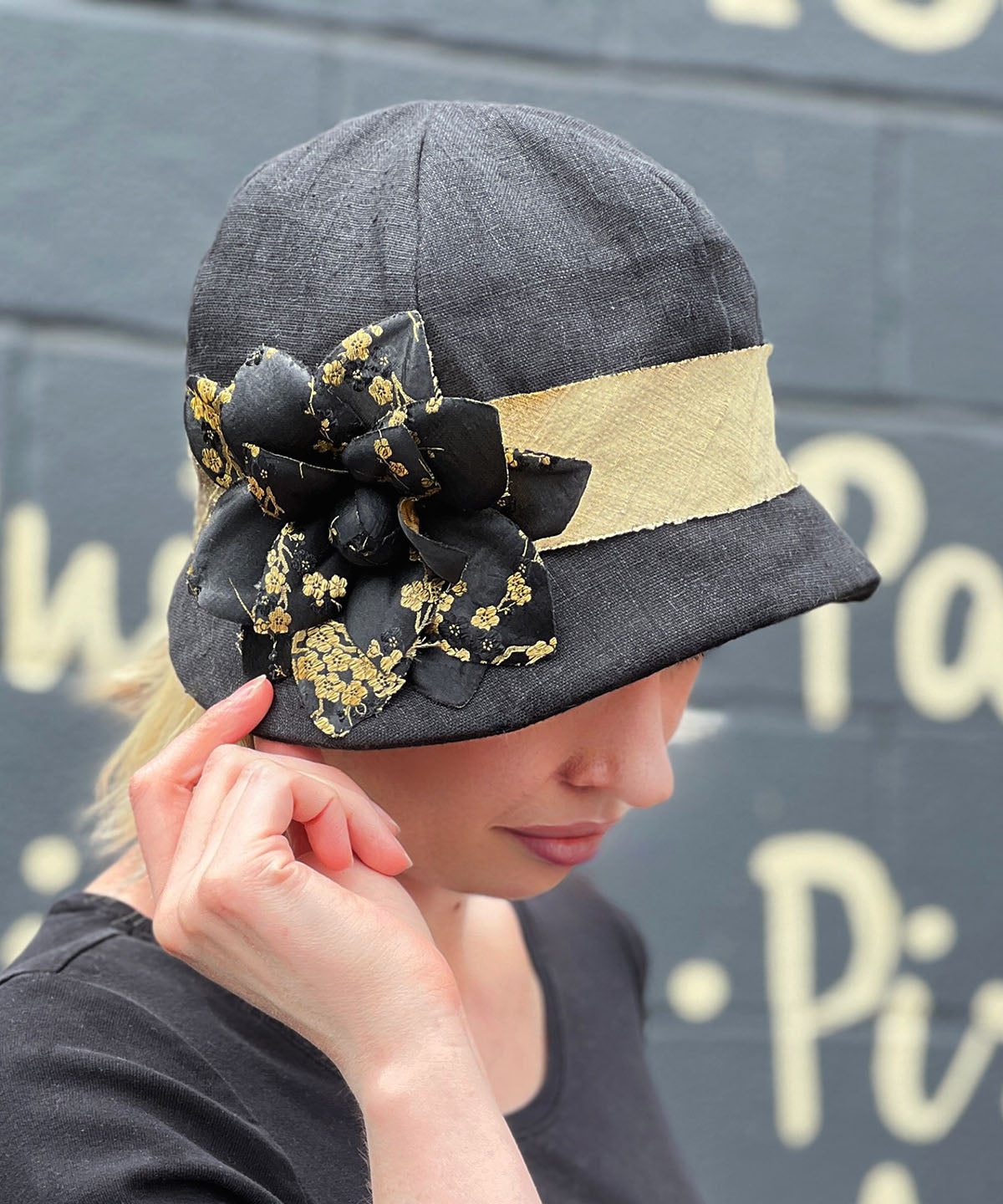 Side view of Model wearing Grace Cloche 1920s Style Hat Linen in Black with Black and Gold Kimono Flower Brooch | Seattle WA USA