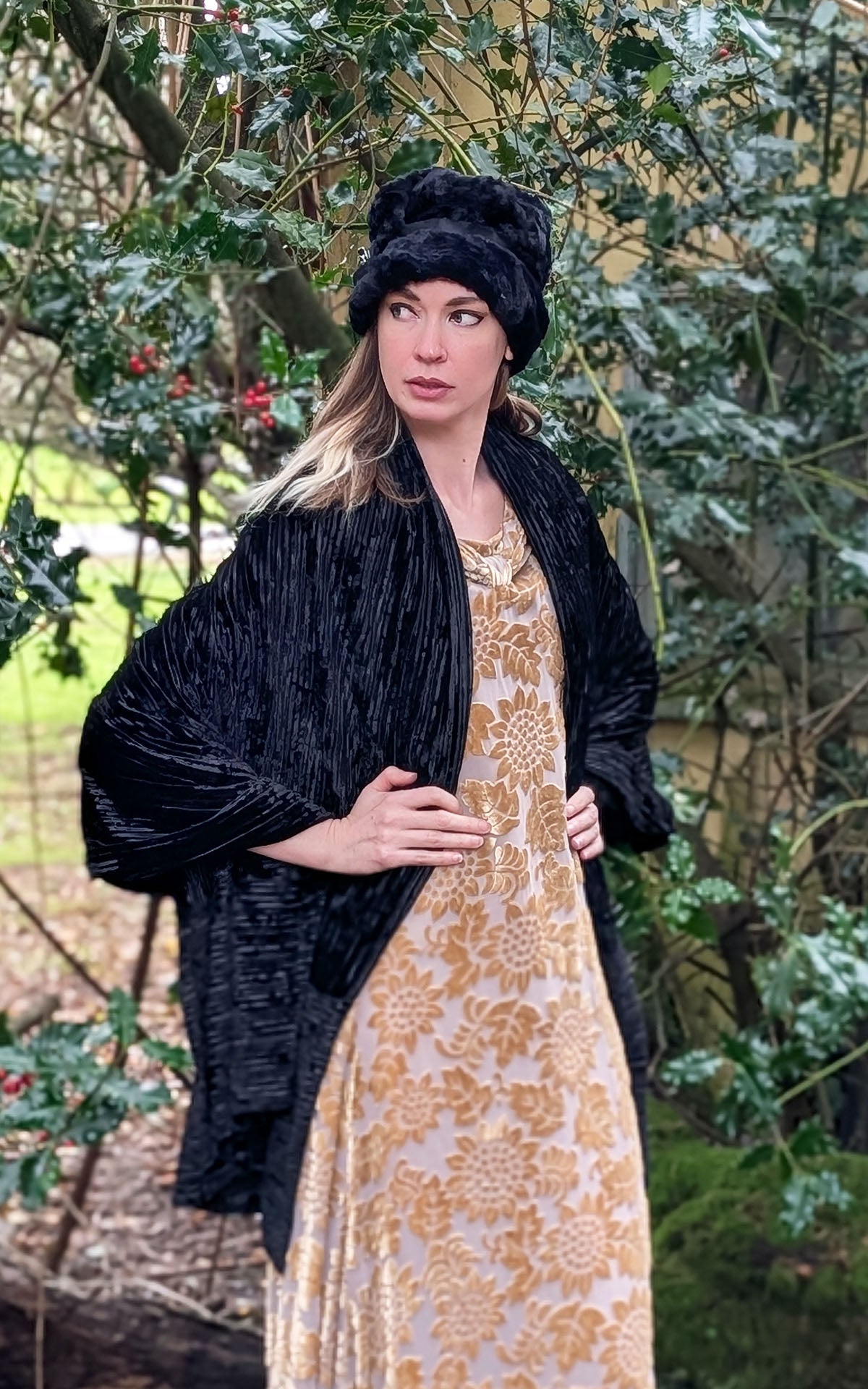 Woman wearing gold dress paired with an Evening Wrap in Night Owl Pleated Velvet handmade in USA by Pandemonium Seattle