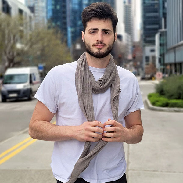 Man standing in street wearing a lightweight Voile scarf by Pandemonium millinery handmade in seattle, WA