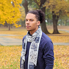 man standing in park wearing navy and ivory handkerchief scarf handmade in USA by Pandemonium Seattle