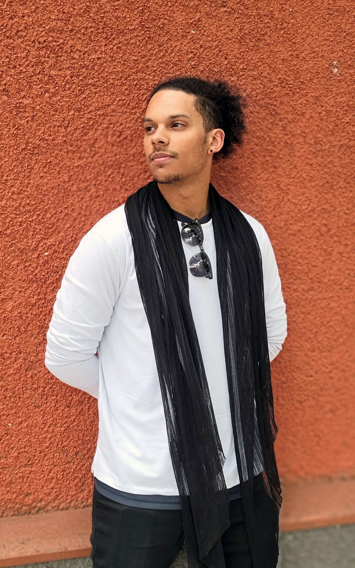 Man against rust wall wearing large Handkerchief scarf | Cotton Voile, Black | Handmade in Seattle WA | Pandemonium Millinery