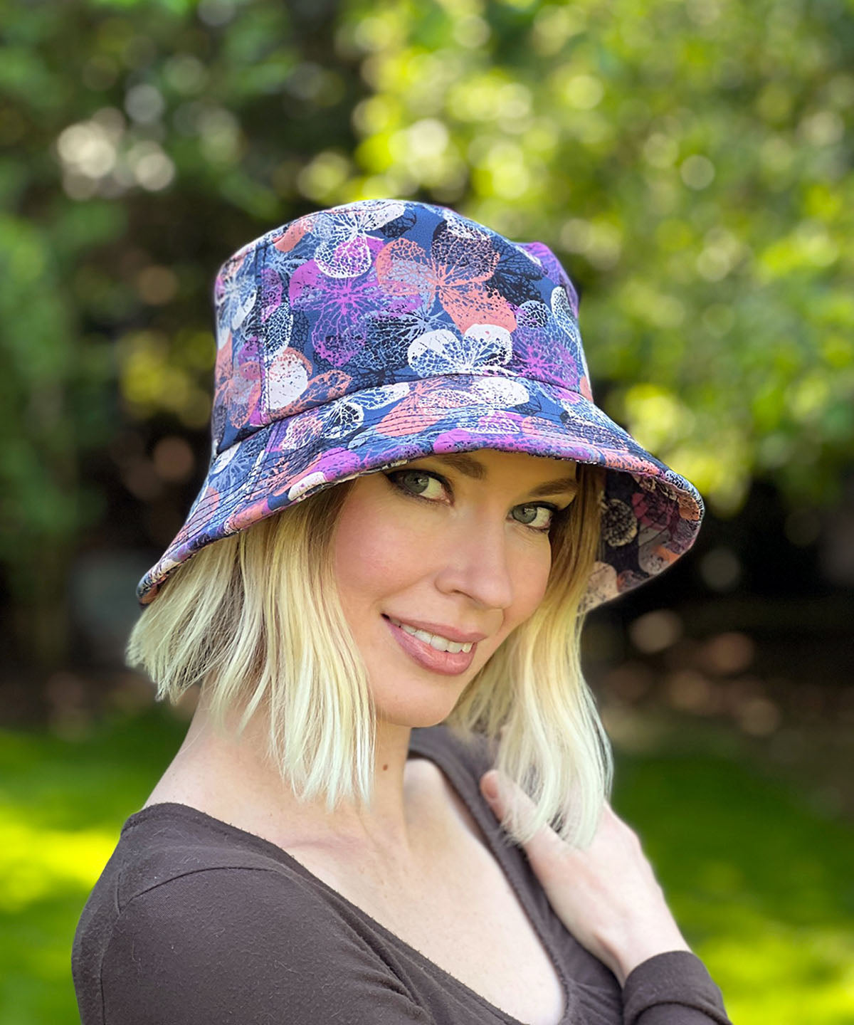 Modeling wearing Hollie Sun Hat in Paper Flowers in Lavender. Handmade in America by Pandemonium Seattle.