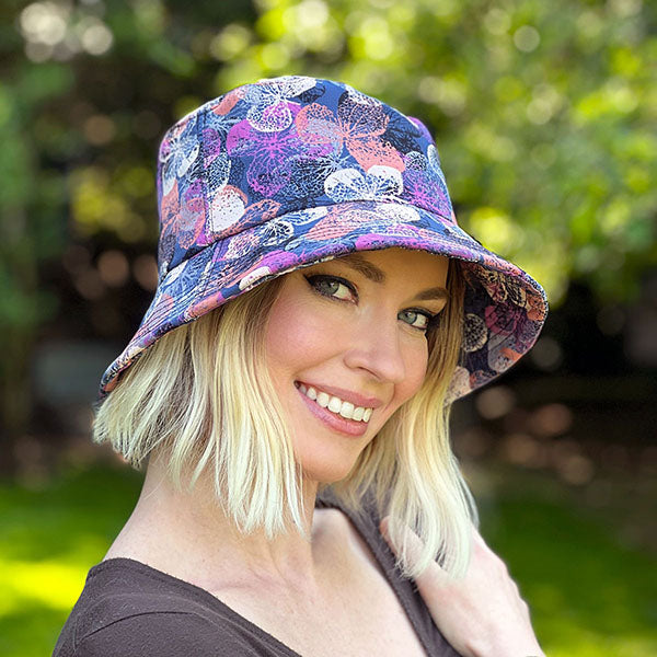 Close-up of a woman smiling while wearing 'The Hollie Hat,' a chic and lightweight sun hat with a structured brim, perfect for summer sun protection handmade by Pandemonium Millinery